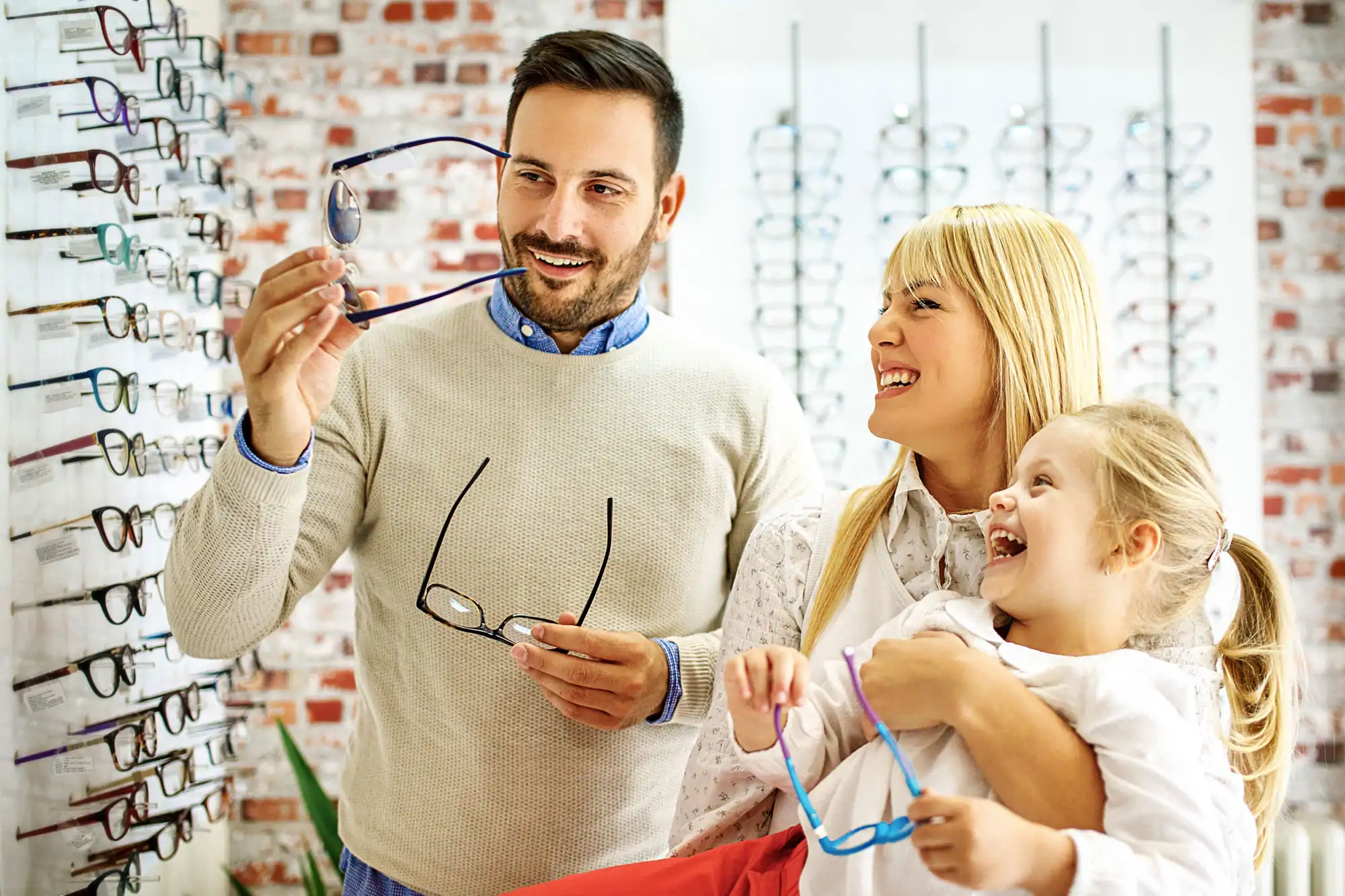 Optician Helping Family With Prescription Glasses